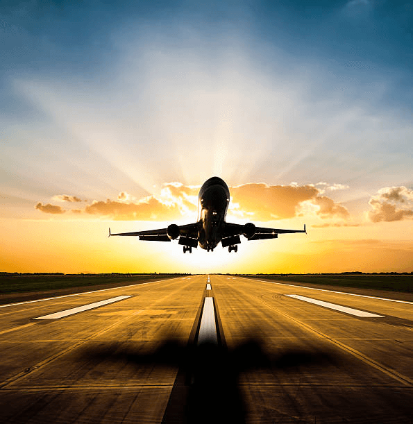 Aircraft taking off at sunset